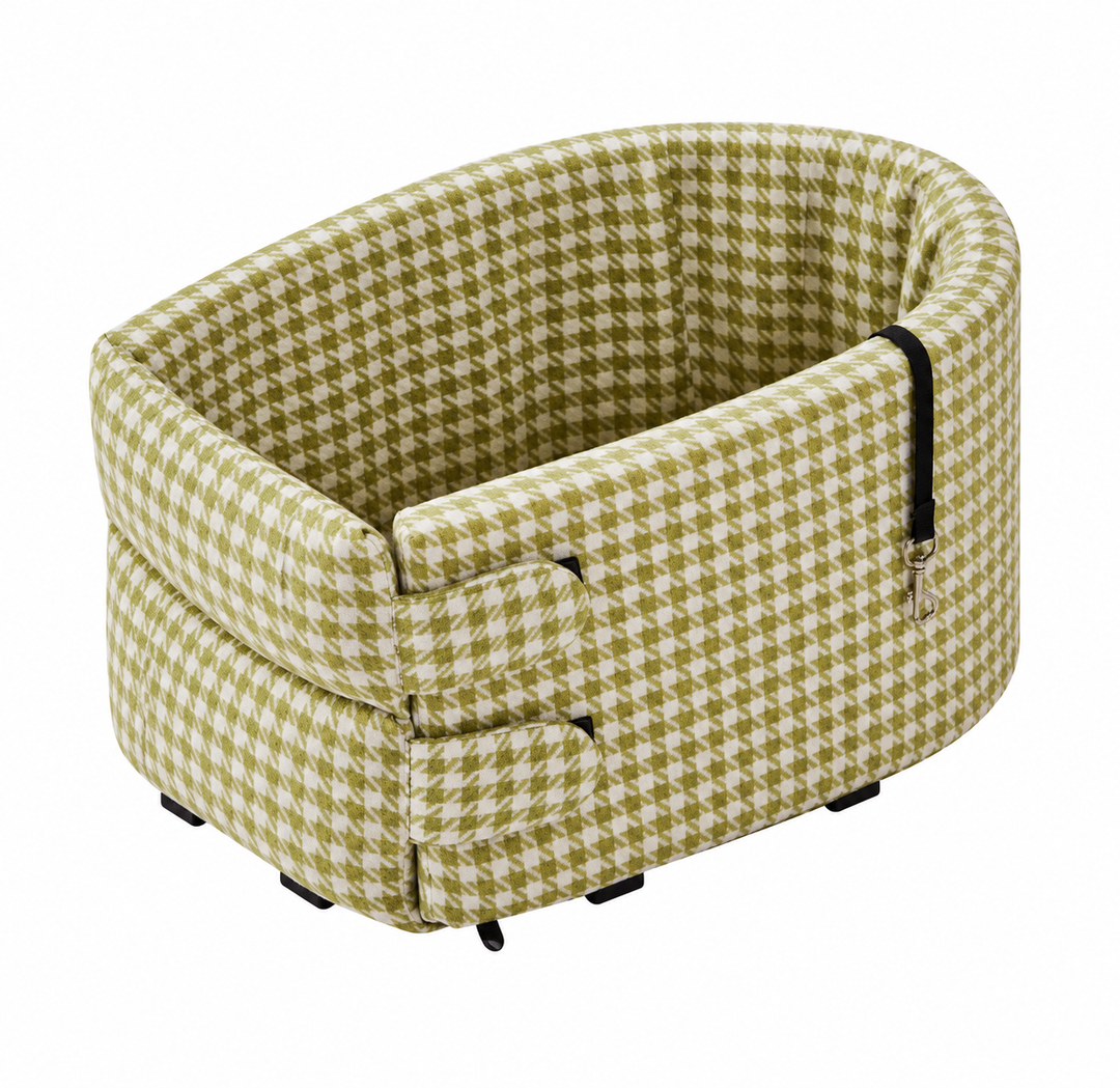 The olive houndstooth travel bed on a plain background, with the belt straps folded out