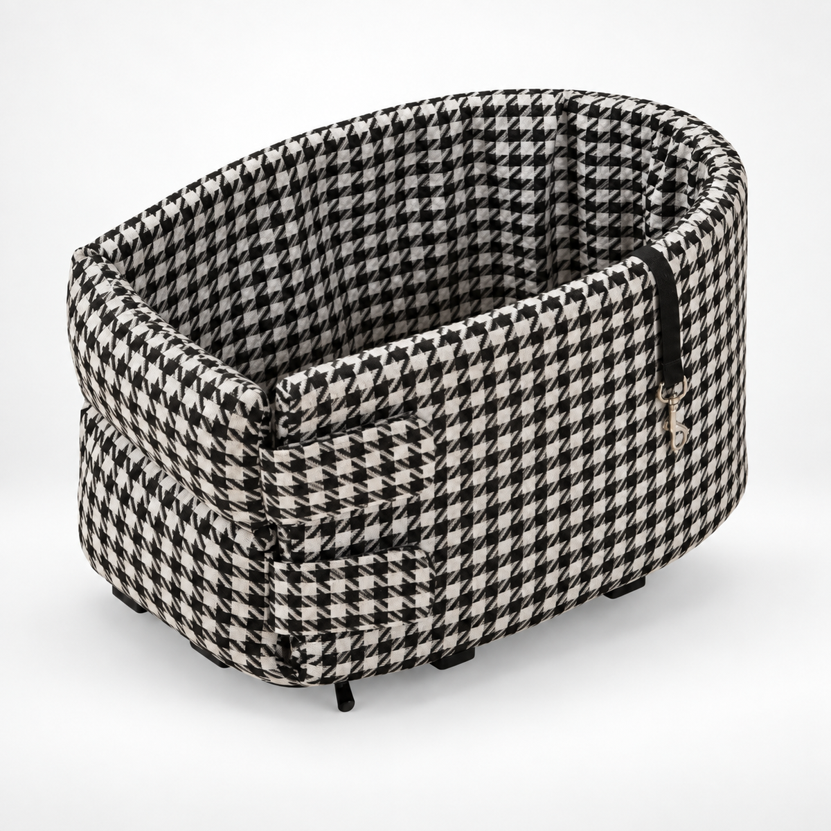 The black and white houndstooth travel bed on a plain background, with the tether clip hanging inside