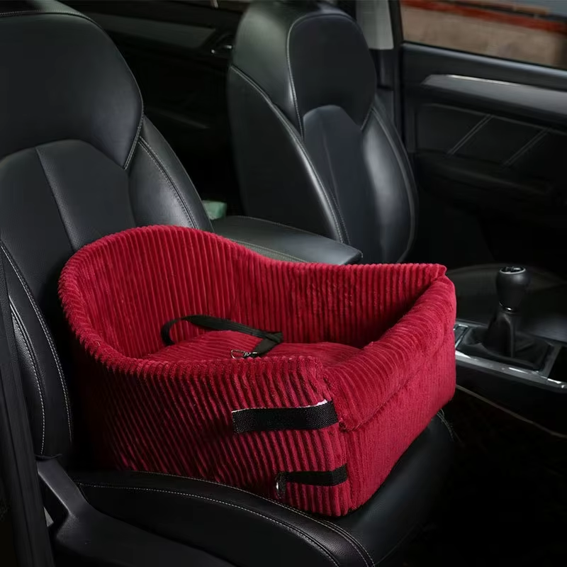 Red pet seat cover on a car seat with black interior