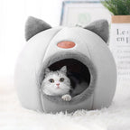 White and gray cat peeking out from a plush gray cat cave bed with cute cat-ear accents, showcasing the cozy enclosed design and soft interior sleeping space. | Pet Grooming | Pet Supplies and Food Australia | Pet Supplies Sydney | PetNexa Australia | Shop now