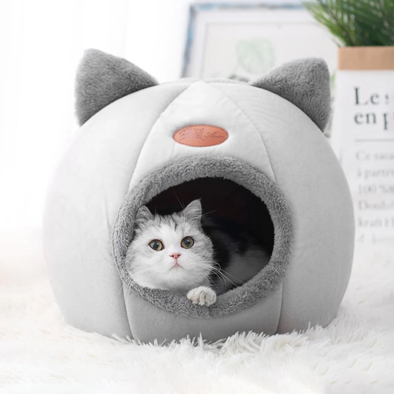 White and gray cat peeking out from a plush gray cat cave bed with cute cat-ear accents, showcasing the cozy enclosed design and soft interior sleeping space. | Pet Grooming | Pet Supplies and Food Australia | Pet Supplies Sydney | PetNexa Australia | Shop now
