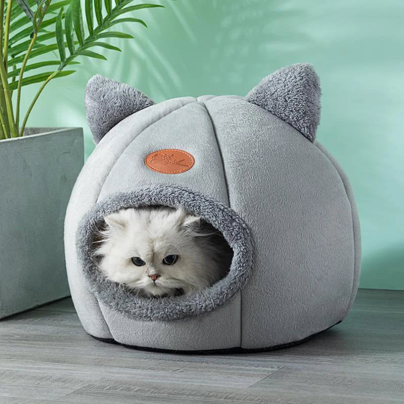 White cat resting inside a gray cat cave bed with plush cat-ear accents and a soft enclosed design, creating a warm, secure hideaway for cats and kittens. | Pet Grooming | Pet Supplies and Food Australia | Pet Supplies Sydney | PetNexa Australia | Shop now