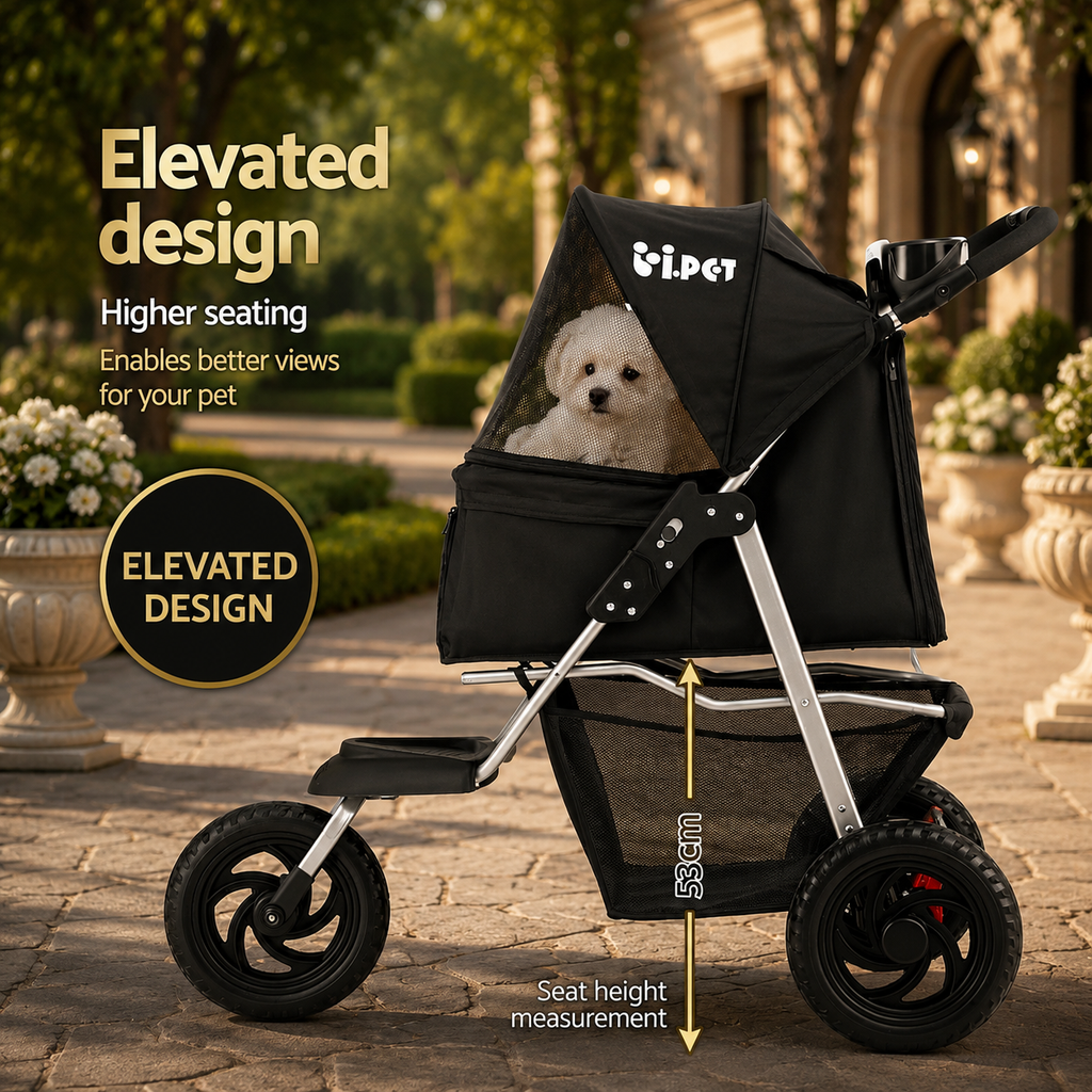 A black pet stroller with a small white dog sitting inside, shown outdoors on a stone walkway with garden plants in the background. The image includes marketing text highlighting the elevated design and seat height measurement.