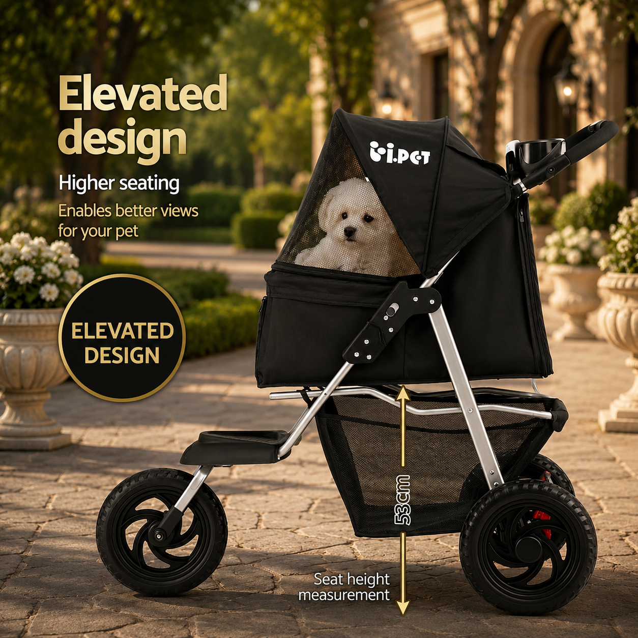 A black pet stroller with a small white dog sitting inside, shown outdoors on a stone walkway with garden plants in the background. The image includes marketing text highlighting the elevated design and seat height measurement.