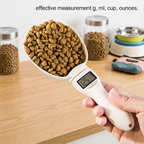 Digital pet food measuring scoop with a digital display held by a hand, surrounded by pet food containers on a wooden surface. | Pet Grooming | Pet Supplies and Food Australia | Pet Supplies Sydney | PetNexa Australia | Shop now