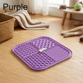 The purple lick mat on a timber floor